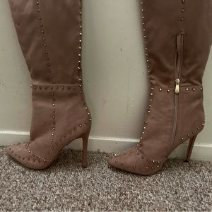 Thigh high boots with gold points.